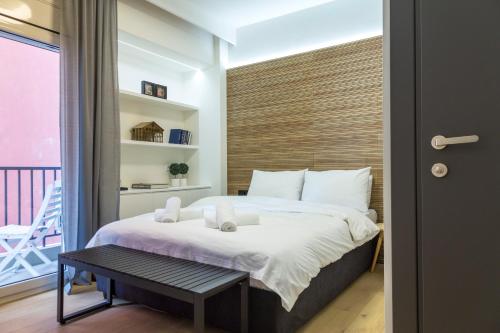 a bedroom with a large bed and a balcony at K2 SUITE in Thessaloniki