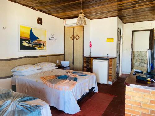 a bedroom with two beds in a room at Pousada Brésil Aventure in Galinhos