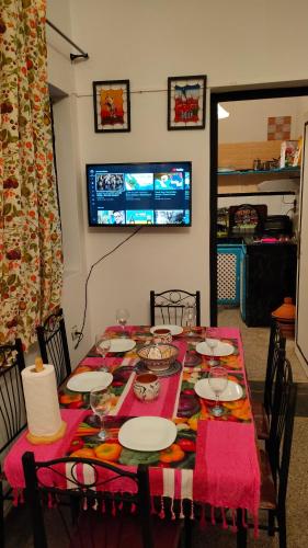 a dining room table with a red table cloth and chairs at Samad apartments in Essaouira