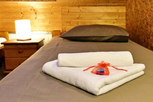 a bed with white towels and a bag on it at Spa Villa Trakai in Trakai