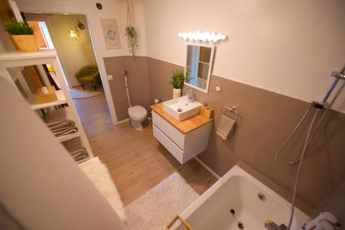 an overhead view of a bathroom with a sink and a tub at Chalet 6 personnes avec sauna in Leysin