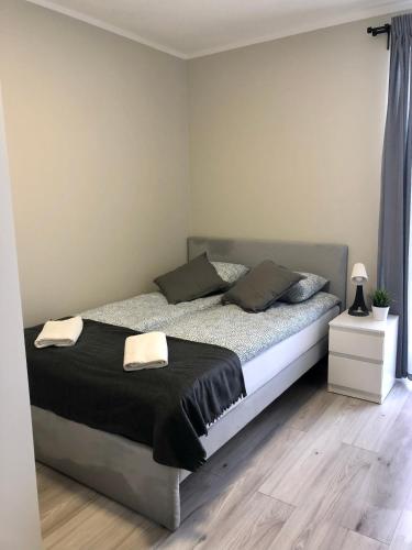 a bedroom with a bed with two towels on it at Gościniec Wigry 2 in Walne