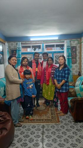 a group of people posing for a picture in a room at ANURAG HOMESTAY in Kurseong