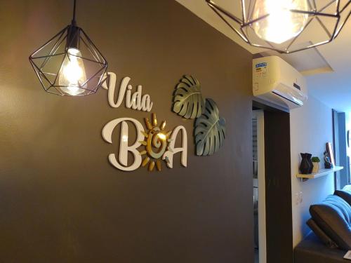 a sign on a wall with the word tala boo at Apartamento Vida Boa in Gravatal
