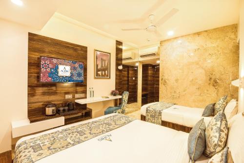 a hotel room with two beds and a bathroom at Hotel Auris & Banquets, Mumbai International Airport in Mumbai