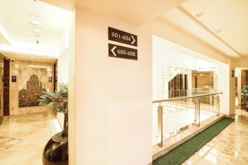 a hallway with a sign on the wall of a building at Hotel Auris & Banquets, Mumbai International Airport in Mumbai