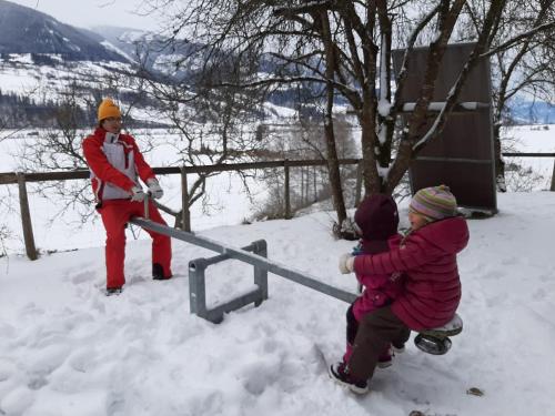 a woman and two children playing in the snow at Apartments Teglbauernhof, Hütte, Chalet, Mobilheim, Appartement, Ferienwohnung, Pension, Urlaub in Uttendorf