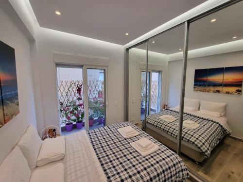a bedroom with two beds and a large window at WOW Penthouse Boutique in the heart of Historical Center in Athens