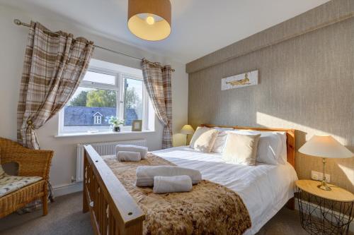 Ένα ή περισσότερα κρεβάτια σε δωμάτιο στο Tunlaw Cottage