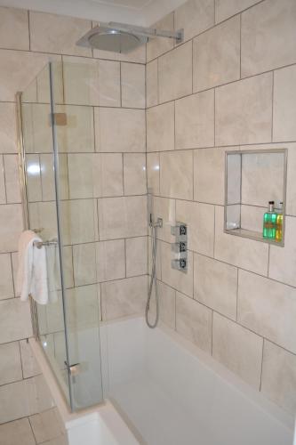 a bathroom with a shower with a glass door at Ternhill Farm House - 5 Star Guest Accommodation with optional award winning breakfast in Market Drayton