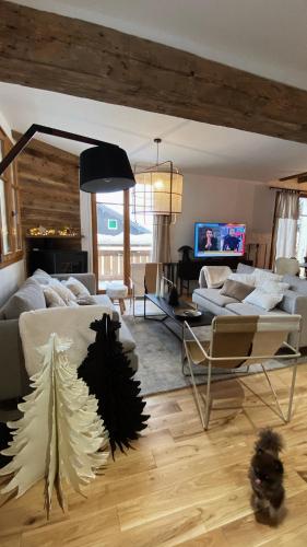a living room with a christmas tree on the bed at Reine Sophie in Megève