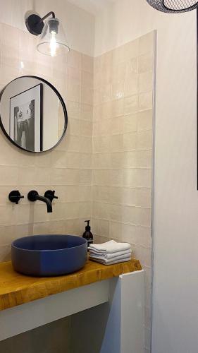 a bathroom with a blue sink and a mirror at Reine Sophie in Megève