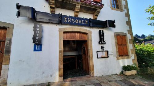 a building with a sign on the side of it at Hostal Ansonea in Bera