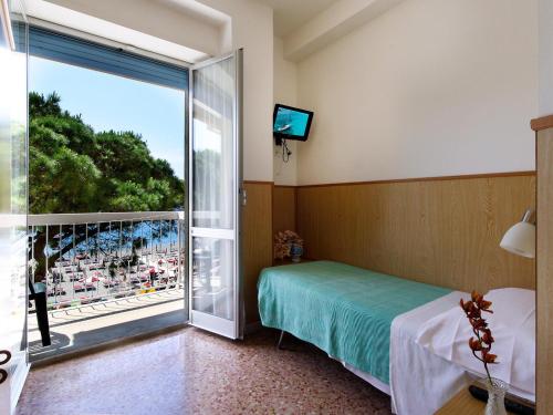 Posteľ alebo postele v izbe v ubytovaní Albergo Anita