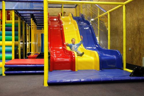 a man sitting on a slide on a playground at Toila Spa Hotel in Toila