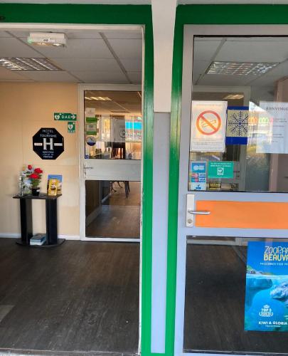 a view of a store with a glass door at Nouvelle Classe Hotel in Châtellerault