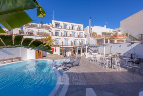 a swimming pool in front of a building at Hotel Boutique Sibarys - Adults Recommended in Nerja