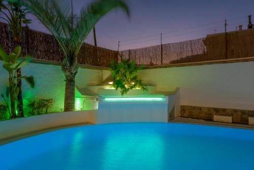 a swimming pool in a house with blue lights at Hotel Boutique Sibarys - Adults Recommended in Nerja
