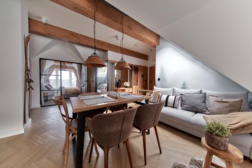 a living room with a table and a couch at Tatra Square Apartments in Zakopane