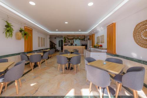 a restaurant with tables and chairs and a counter at Hotel Boutique Sibarys - Adults Recommended in Nerja