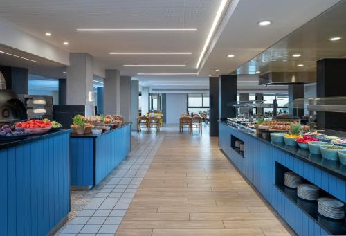 a buffet line in a restaurant with food on display at Kfar Giladi Hotel in Kefar Gil‘adi