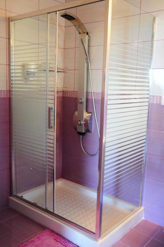 a shower with a glass door in a bathroom at Haven Beach in Faliraki
