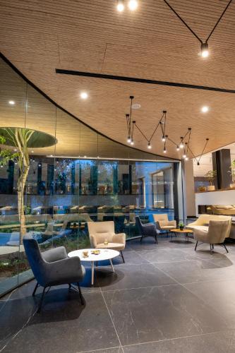 a lobby with couches and chairs and a table at Kfar Giladi Hotel in Kefar Gil‘adi