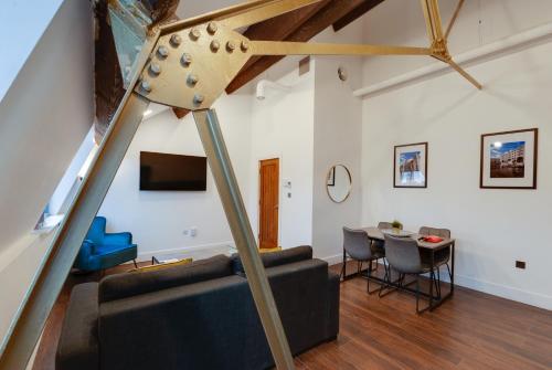 a living room with a couch and a table at Mathew Street City Centre Apartments by Happy Days in Liverpool