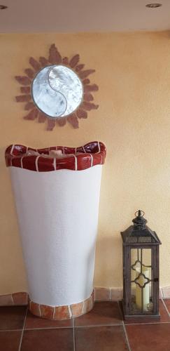 a coffee cup on a table next to a lantern at Sportpension Alpenrose in Schladming