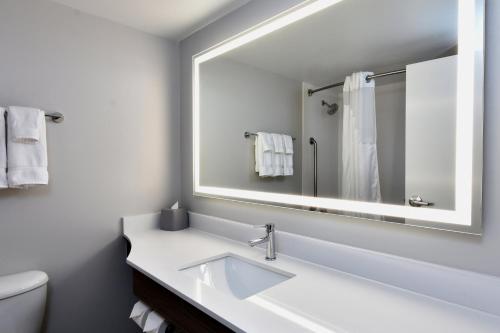 a white bathroom with a sink and a mirror at Holiday Inn Express Richmond I-64 Short Pump Area by IHG in Richmond