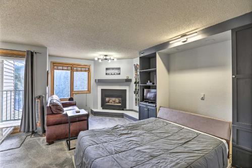 a bedroom with a bed and a fireplace at Cozy Ski-InandOut Winter Park Studio with Hot Tubs! in Winter Park