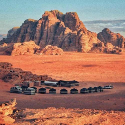 a train station in the desert with a mountain at Wadi Rum Travel camp in Wadi Rum