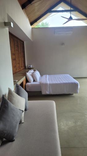 a bedroom with two beds and a window at Arachchi Heritage in Anuradhapura
