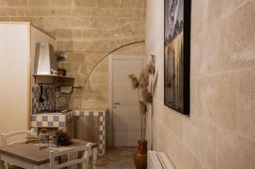 eine Küche mit einem Tisch, einem Tisch und einem Herd in der Unterkunft Antichi Orizzonti in Matera