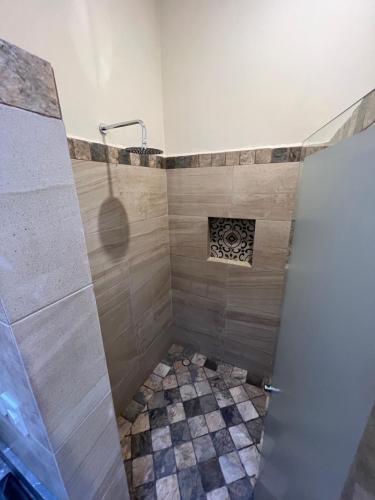 a shower with a glass door in a bathroom at Mesón de las Delicias in Cuernavaca