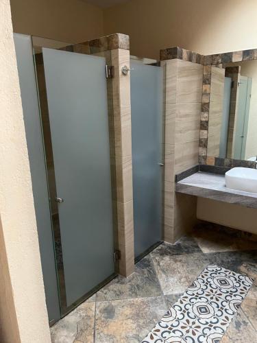 a bathroom with a shower and a sink at Mesón de las Delicias in Cuernavaca