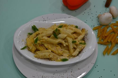 a white bowl of pasta on a plate with carrots at Blaire Executive Suites in Manama