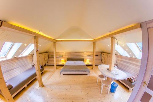 a room with a bed and a table in a room at Hata Hutsula in Mykulychyn