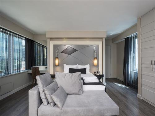 a bedroom with a large bed and a couch at Bilek Hotel Kavacık in Istanbul
