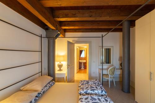 a bedroom with a bed and a desk in a room at Youatmolino Canal View Apartment in Venice
