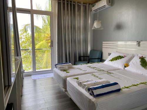 Ένα ή περισσότερα κρεβάτια σε δωμάτιο στο VIVA Beach Maldives