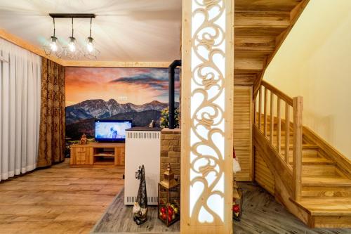 a living room with a mural of a mountain at Komfortowe domki na wynajem - Holiday Tatry in Poronin