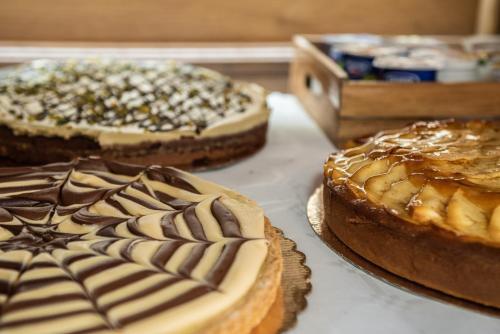 three cakes sitting on a table next to each other at Albergo Ad Astra in Pescasseroli
