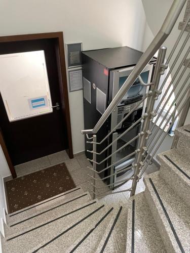 a set of stairs leading up to a black door at dS Hotel Gronau in Gronau