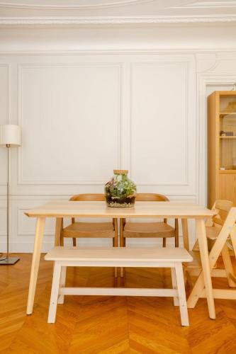 - une table et des chaises en bois dans l'établissement Bel appartement dans le 9ème, à Paris