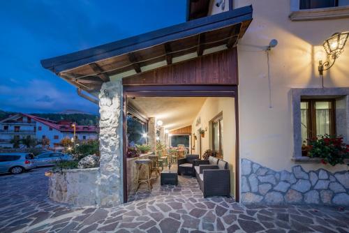 a building with a patio with a table and chairs at Albergo Ad Astra in Pescasseroli
