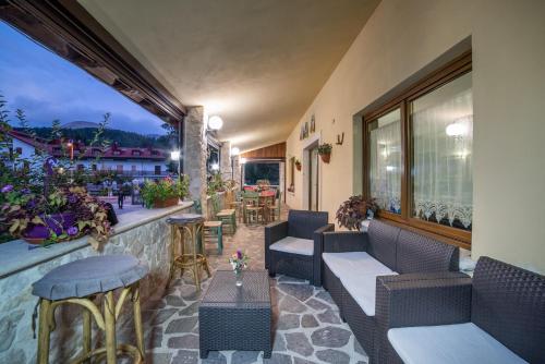 a patio with chairs and tables on a building at Albergo Ad Astra in Pescasseroli