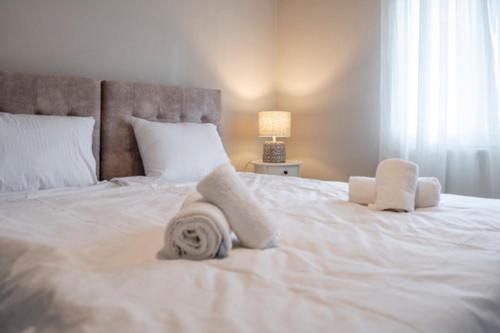 a large white bed with two pillows on it at Chara’s Luxury home in Kalabaka