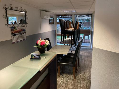 a dining room with a table and chairs in a room at Nouvelle Classe Hotel in Châtellerault