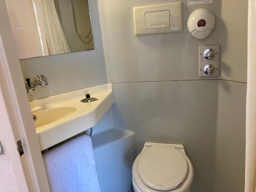 a small bathroom with a toilet and a sink at Nouvelle Classe Hotel in Châtellerault